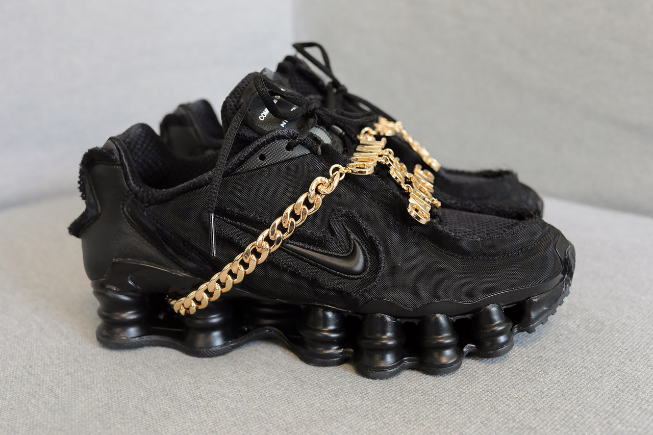 black nike shoes with gold swoosh